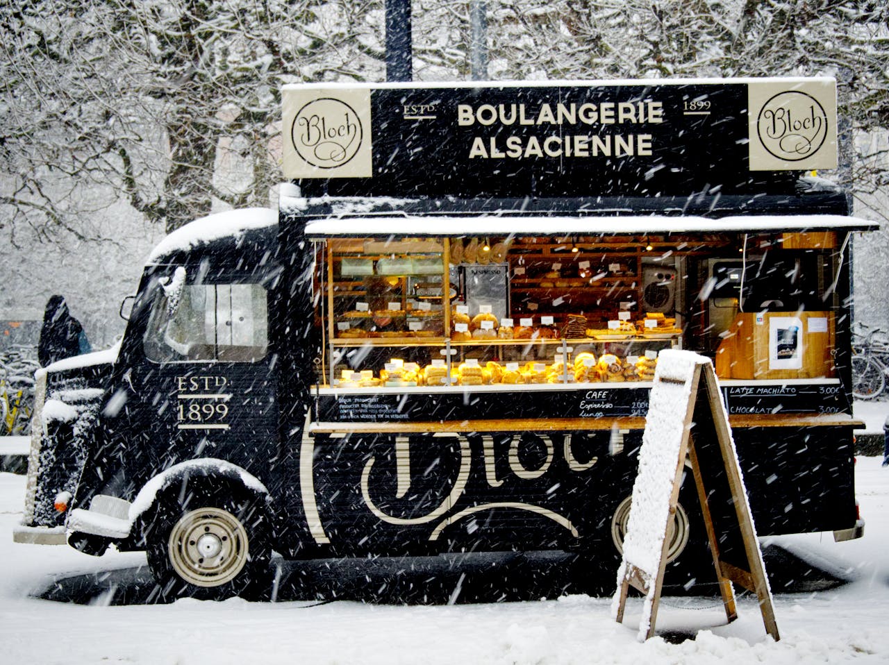 The Art of Drawing Readers In: Your attractive post title goes here A vintage food truck in a snowy urban setting, offering baked goods and warmth during winter.